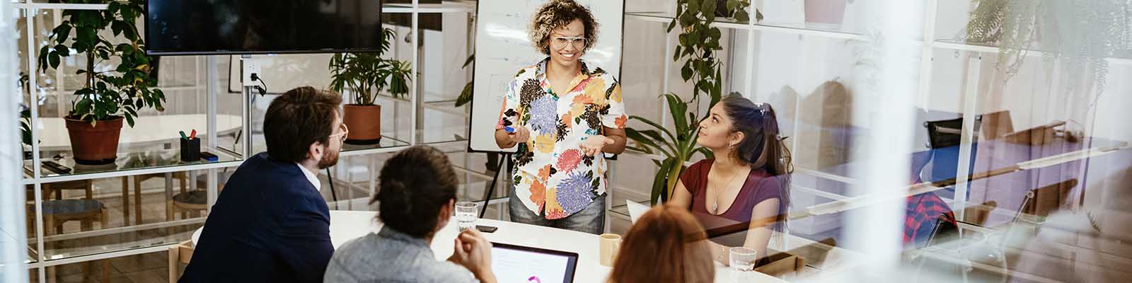 Office colleagues happily having a discussion in the conference room