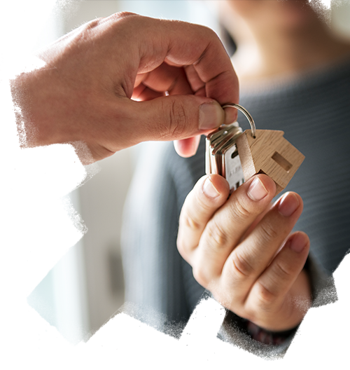 Real estate consultants handling keys of residential apartment to customer