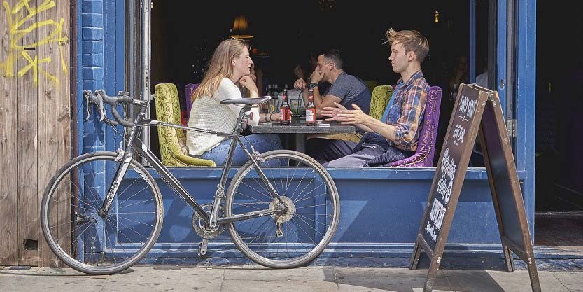 Couples sitting in pub and enjoying their drinks