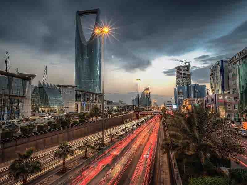 Night view of Saudi Arabia highway with commercial building on the side of highway