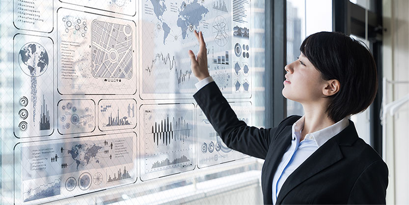 Professional woman interacts with data dashboard on smart board