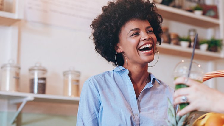 woman laughing in coworking kitchen