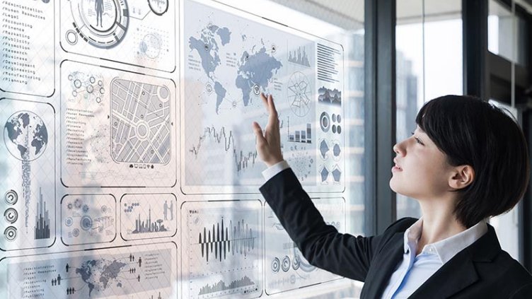 Professional woman interacts with data dashboard on smart board