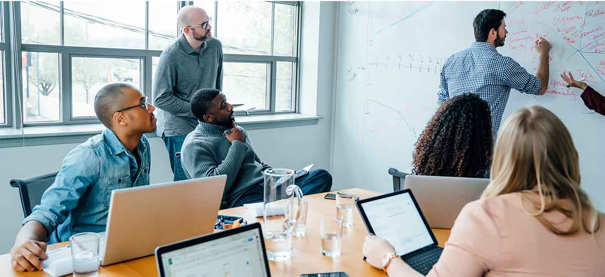 Business people using whiteboard in meeting